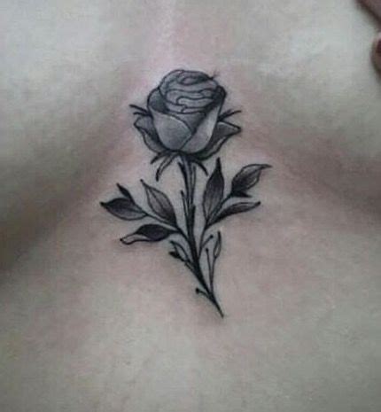 small rose tattoo between breast|Rose tattoo between breast